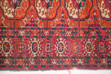 Vintage Tekke rug border: geometric patterns in madder, aubergine, blue, ivory, with flat weave kilim.