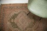 Worn corner of an unusual green silk Turkish Kayseri rug with intricate border design.