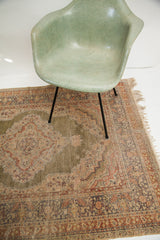 Intricate floral motifs and worn green field on a vintage Kayseri silk rug.