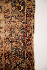 Antique Kerman rug border with unique cloudband motif, teal, red, and beige floral designs.