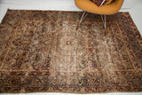 Antique Kerman rug corner with unusual cloudband border and worn traditional patterns.