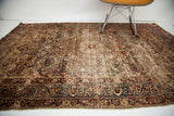 Patina and distinct curvilinear cloudband border on an antique Kerman rug.
