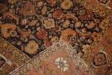 Antique Caucasian rug corner: walnut brown herati field, rust border, and low pile texture.