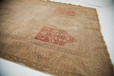 Washed-out blanched panel design with muted red motifs and faded paisley border.