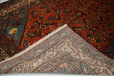 Hand-knotted foundation and ivory border pattern revealed on the folded corner of the Malayer rug.
