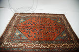 Persian Malayer rug's lustrous red field with blue corners and dramatic tonal variation.