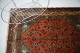Persian Malayer rug's red Herati field, fantastic blue corner, and ivory border.