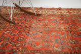 Worn texture of a vintage Hamadan rug, cranberry rose field, blue, ivory, walnut Herati motifs.