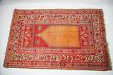 Vintage Anatolian prayer rug, vibrant orange field, cranberry red and blue geometric borders.