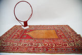 Vibrant orange field and cranberry red, grey-blue border on a vintage Anatolian prayer rug.