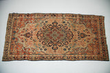 Antique Senneh Baft corner with sprawling rust and ivory curvilinear arabesques.