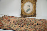 Fine antique Senneh Baft rug, ivory field with dark blue medallion, teal, and rust arabesques.