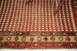 Intricate Caucasian geometric borders and diamond harlequin pattern on this antique Armenian rug.