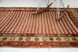 Antique Armenian Harlequin rug with madder red diamond pattern, aged texture, and geometric border design.