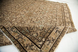 Folded corner of antique Hamadan rug, blanched herati pattern, light blue and ivory border.