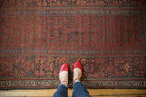 Antique Kurdish runner's deep red field with repeating boteh and detailed geometric borders.