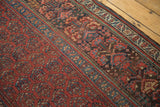 Antique Kurdish runner detail: repeating red field boteh with complex blue and rust tribal border.