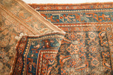 Vintage Persian Hamadan rug corner, showing worn Herati design, teal border, and woven backing.