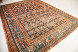 Decorative wear on vintage Persian Hamadan rug corner, teal border, blue Herati motif.