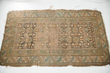 Muted geometric border, featuring serrated leaf motif, on tattered antique Caucasian runner.