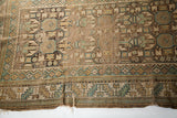 Frayed lower edge and geometric serrated border of an antique Caucasian runner.