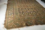 Antique Caucasian runner's classic serrated leaf border in muted green and beige.