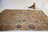 Subtle wear on geometric tribal motifs in ivory, chocolate, and medium blue.