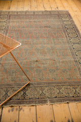 Antique Mohtashem Kashan rug, allover paisley boteh motif, rust ground, and visible wear.