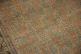 Antique Mohtashem Kashan rug detail: blue paisley boteh motifs, rust field, wear, small holes.