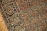 Close-up of antique Kashan rug displaying historic wear, splits, and paisley boteh motif.