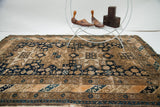 Intricate tan geometric animal motifs on the dark indigo field.