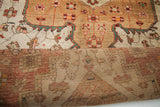 Folded vintage Josan Sarouk rug, showcasing sand, ivory field detail and its hand-knotted reverse.