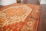 Sand medallion, rhubarb spandrels, and charcoal border of a traditional Josan Sarouk rug.