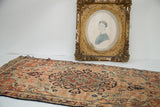 Ornate shabby gold gilt frame displaying an oval hand-drawn Victorian portrait.