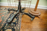 Vintage dress form's distressed black cast iron base and original metal wheels.