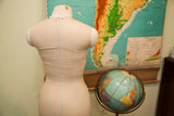 Back of mid century dress form with original beige canvas, metal zipper, and neck discoloration.