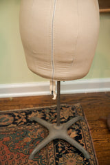 Beige canvas mid-century dress form's lower body, metal zipper, and star stand.