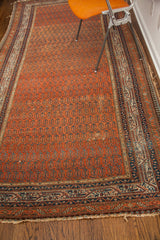 Antique Persian Serbend runner corner: madder root red boteh field, dark blue border, natural fringe wear.
