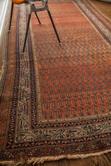 Antique Persian Serbend runner's intricate border, madder red field, and historically worn fringe.