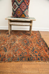Antique Turkmen Beshir rug's storied wear on deep brick red and blue patterns.