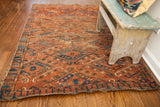 Tattered edge and intriguing brick red and blue border on an antique Beshir rug.