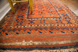 Geometric border, striped flatweave end, and textured fringe on this antique Belouch rug.