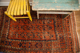 Antique Belouch runner's geometric patterns with time-softened rust and excellent dark blue.