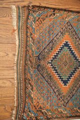 Geometric blue abrash and orange patterns with worn fringe on an antique Beshir runner.