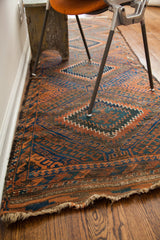 Antique Beshir runner's original worn fringe with deep walnut brown and gradated blue abrash.