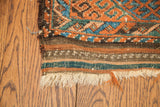 Antique Beshir runner's kilim end, featuring striped bands, delicate white pattern, and natural fringe.