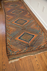 Antique Beshir runner's rich orange, dark walnut, abrash blues, and complex geometric patterns.