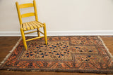 Antique Belouch prayer design rug, soft walnut brown field, peachy brick red border.