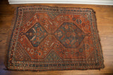 Antique tribal Shiraz rug corner, featuring serrated leaf motifs and finished border details.
