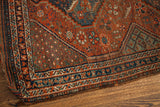 Antique Tribal Shiraz rug border showing deep red, blue, green serrated leaf motifs.